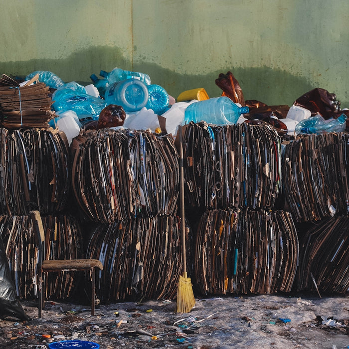 a pile of trash sitting next to a green wall