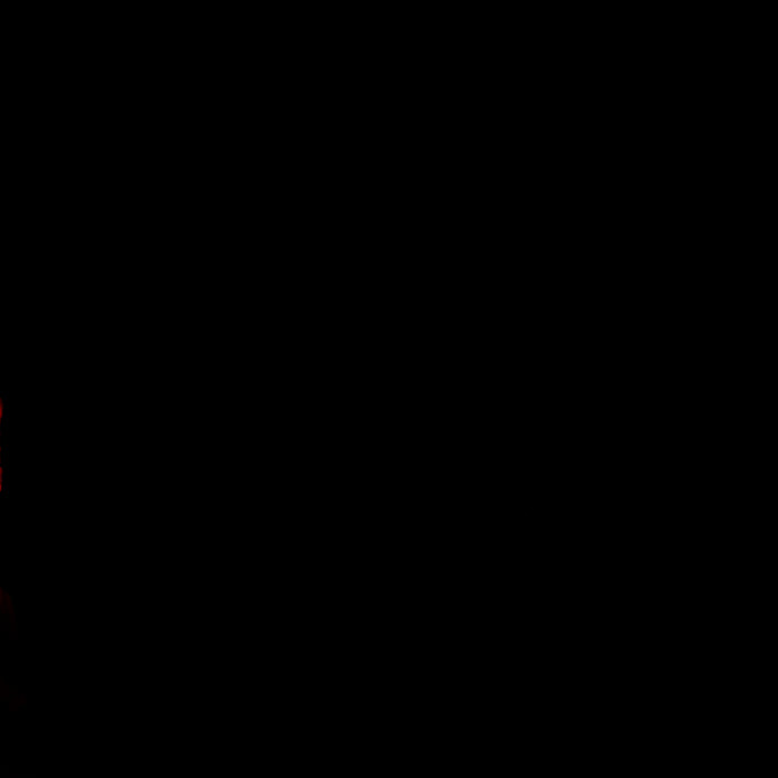 a person standing on top of a red object in the dark