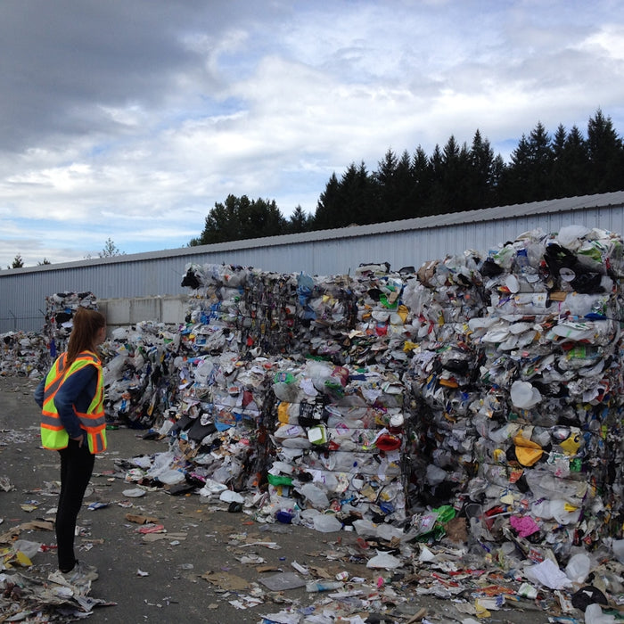 woman standing in front garbage