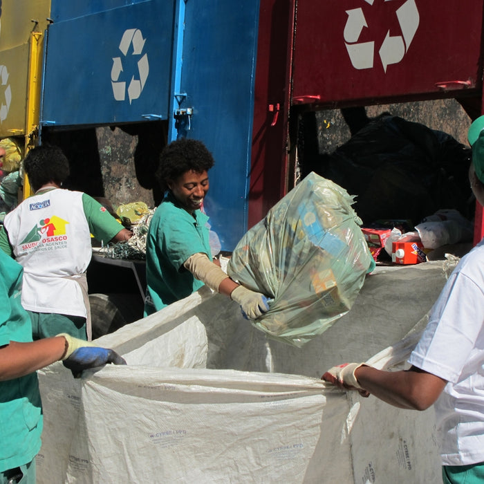 group of people sorting recycled bins