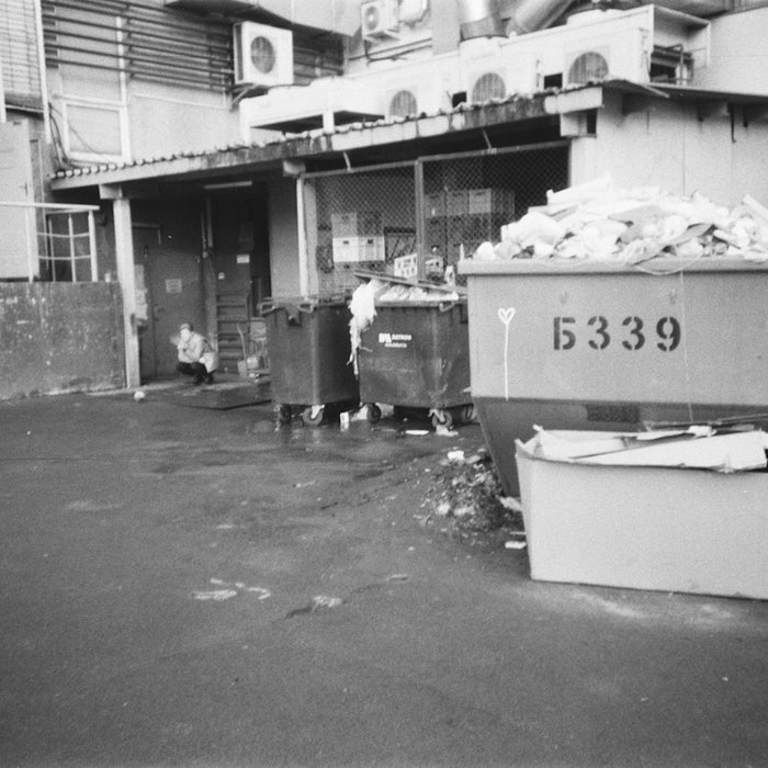 grayscale photo of garbage bins