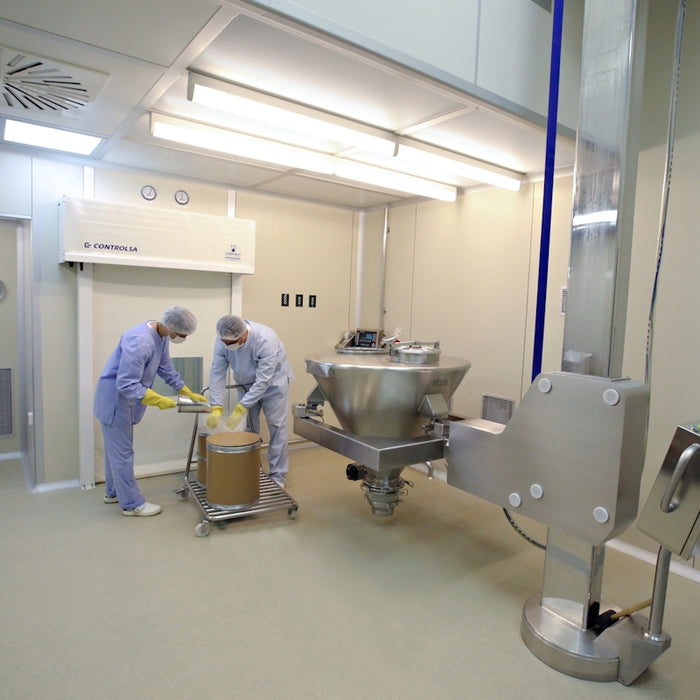 man in blue dress shirt standing beside white and silver water dispenser