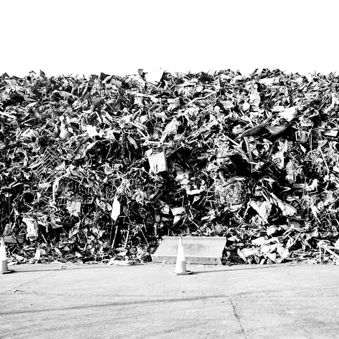 grayscale photo of garbage bags on the street