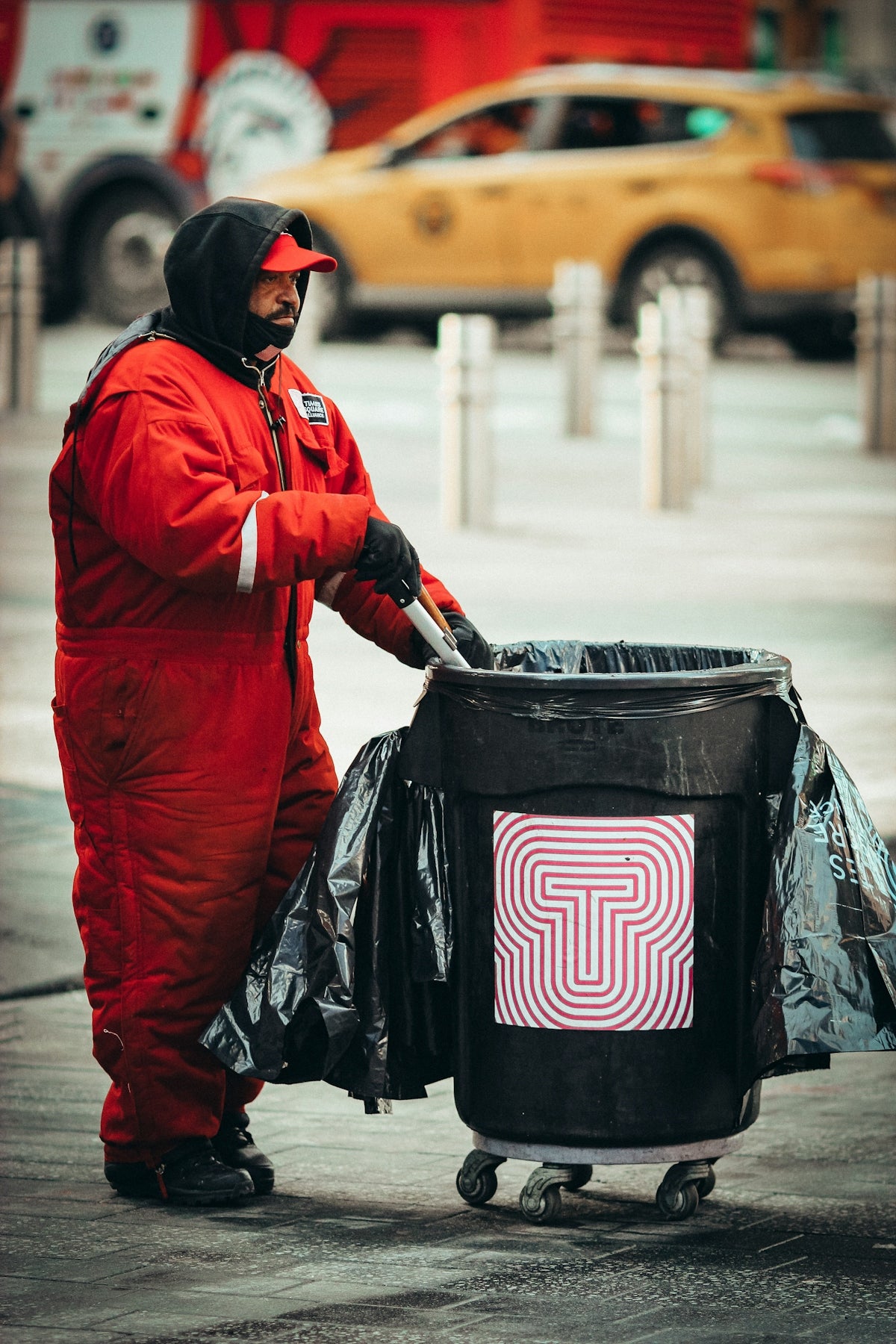 person in red jacket carrying black and pink nike backpack