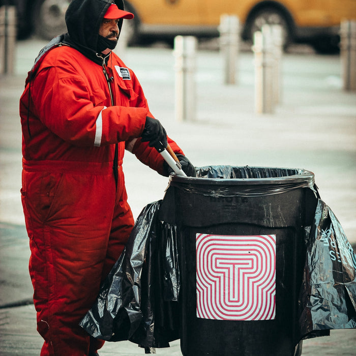 person in red jacket carrying black and pink nike backpack