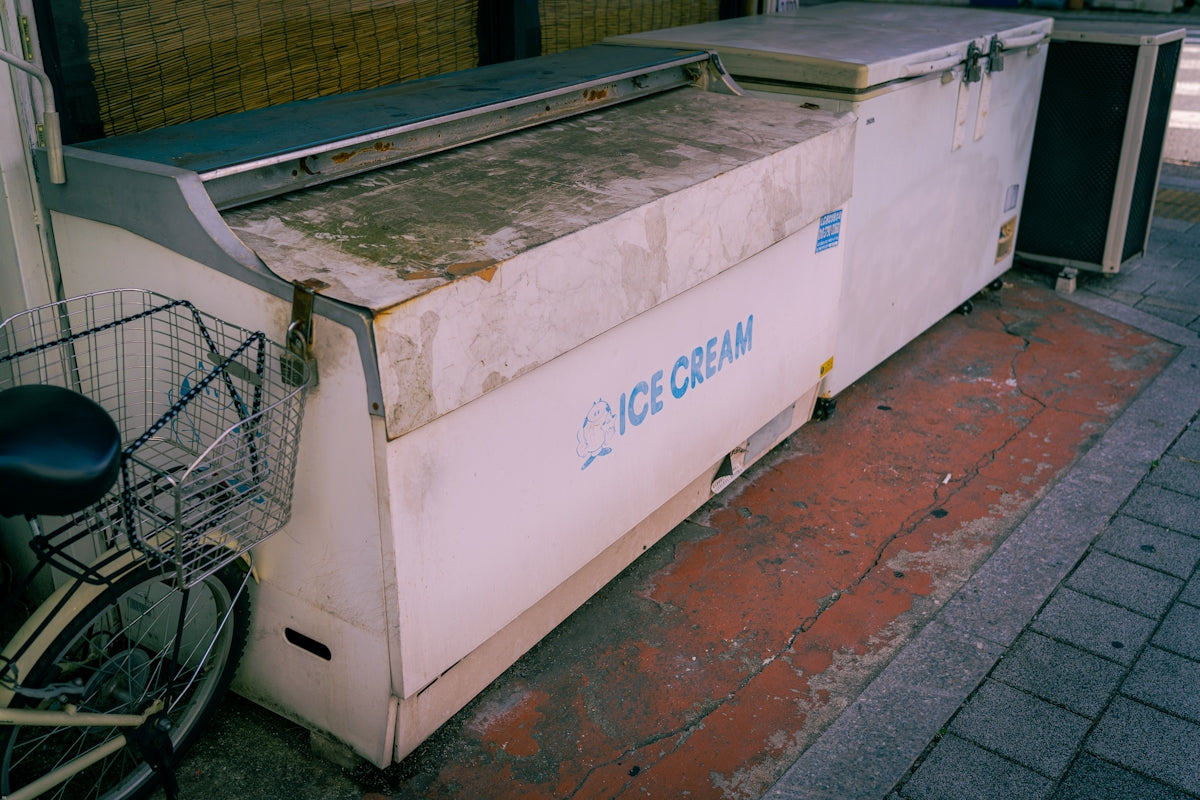 a bike parked next to a large white box