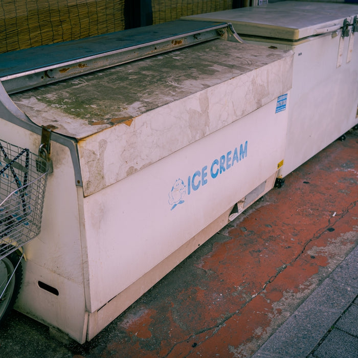 a bike parked next to a large white box