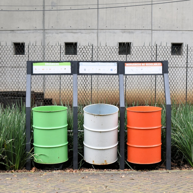 a bunch of barrels that are sitting in the grass