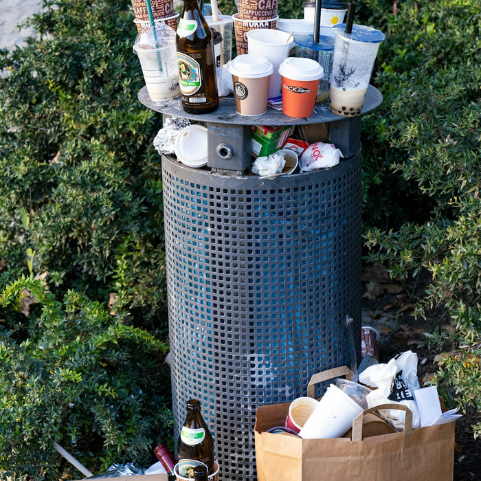 a trash can filled with lots of bottles