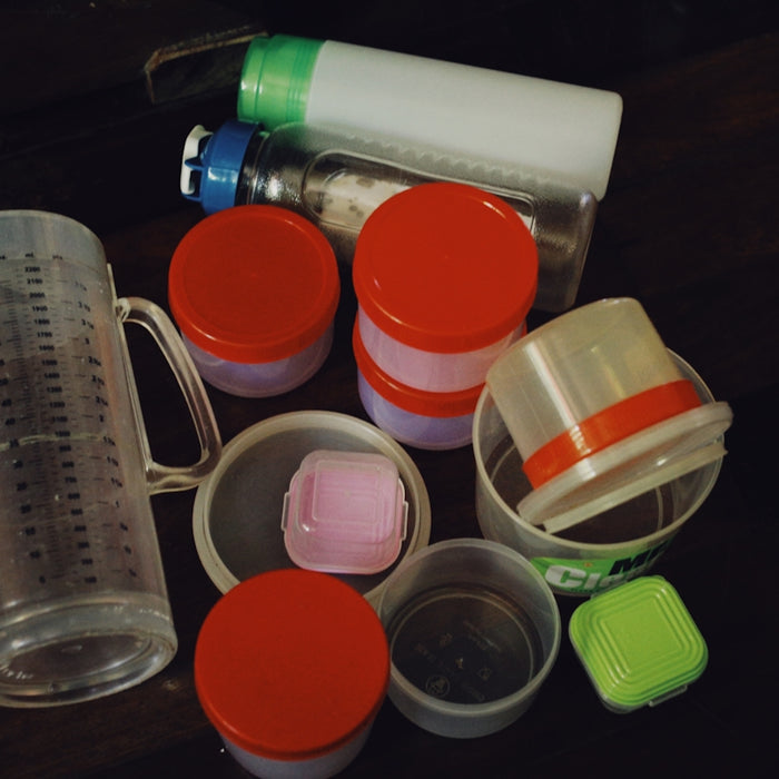 a table topped with plastic containers and containers