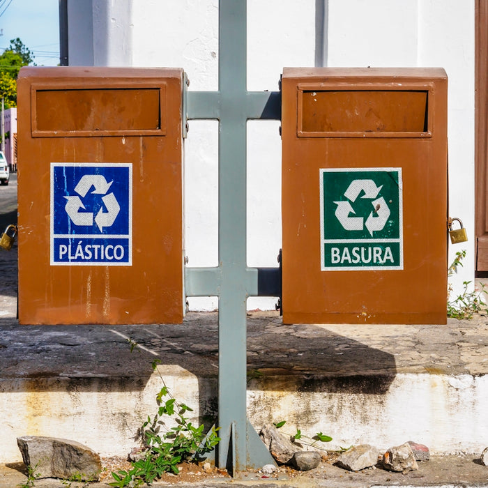 a couple of brown boxes sitting on the side of a road