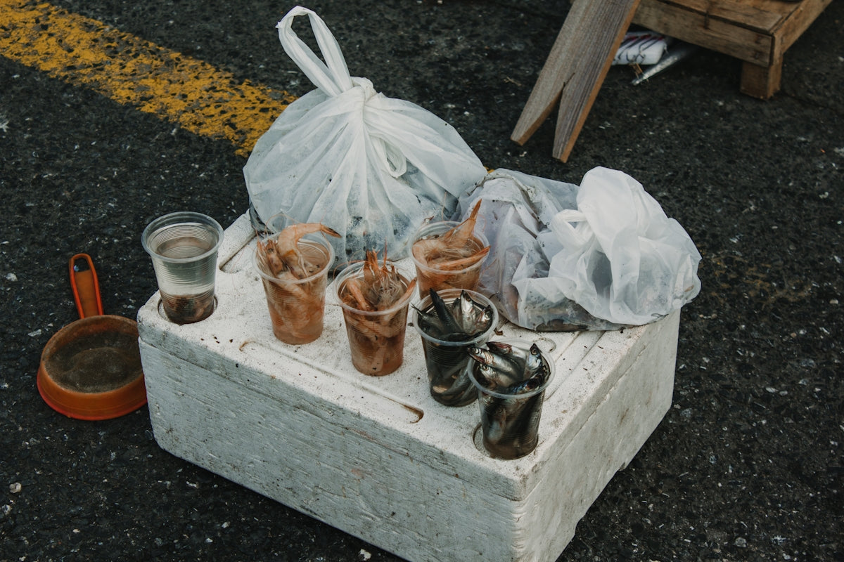 a bunch of cups and a bag on the ground