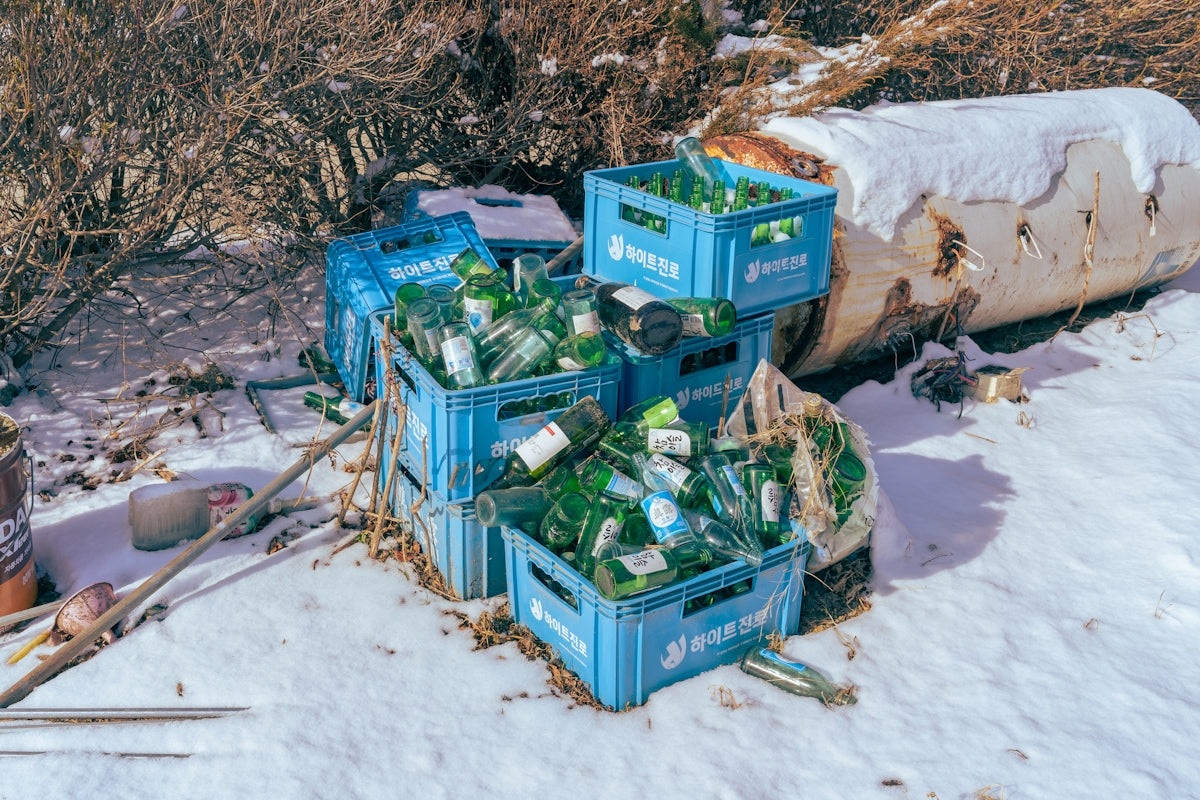 a pile of crates sitting on top of a snow covered ground