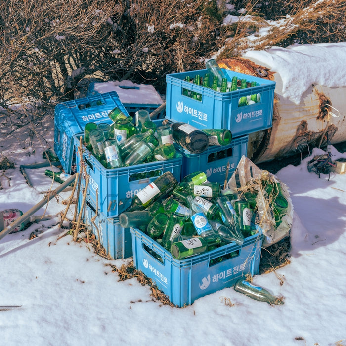 a pile of crates sitting on top of a snow covered ground
