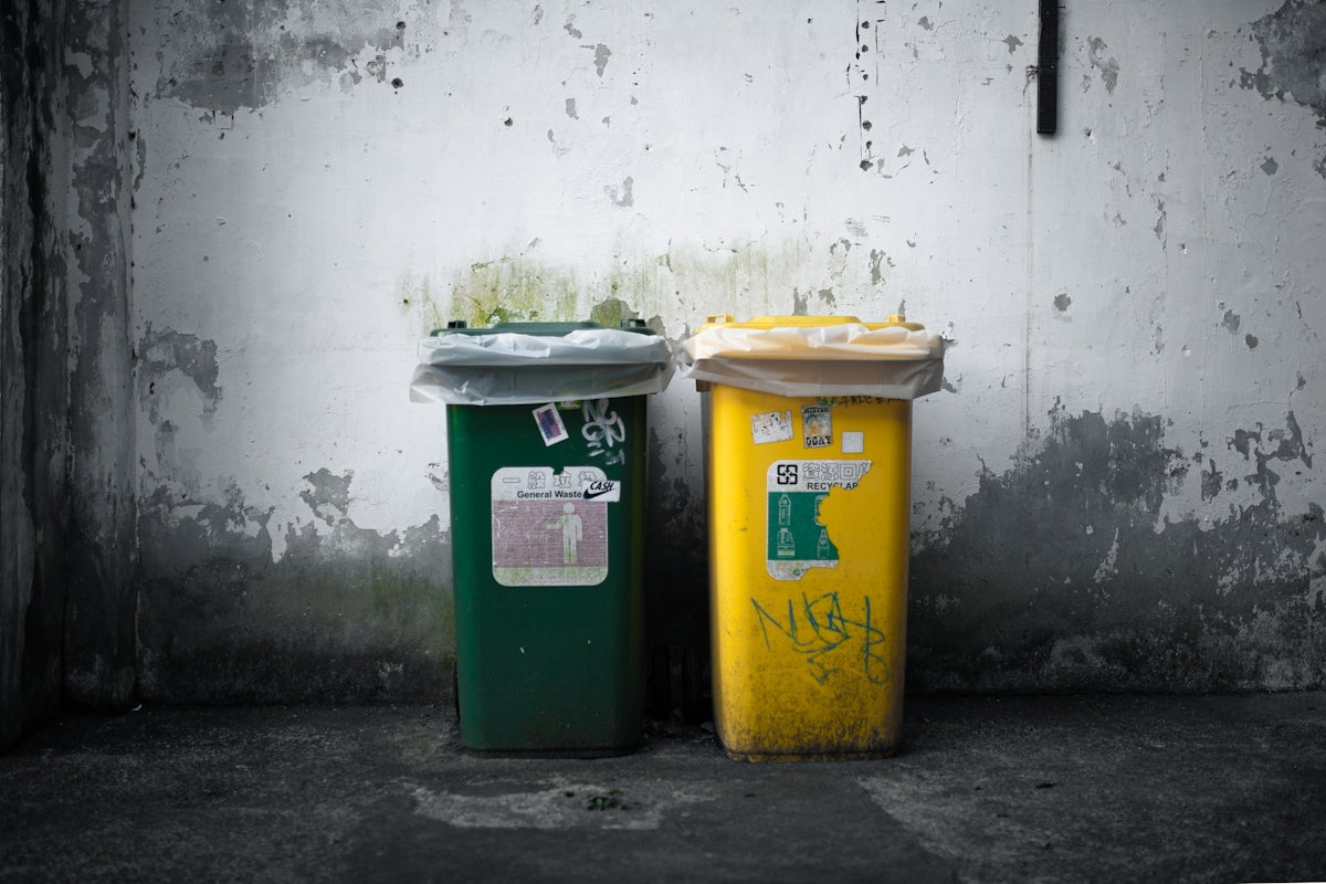 a couple of trash cans sitting next to each other