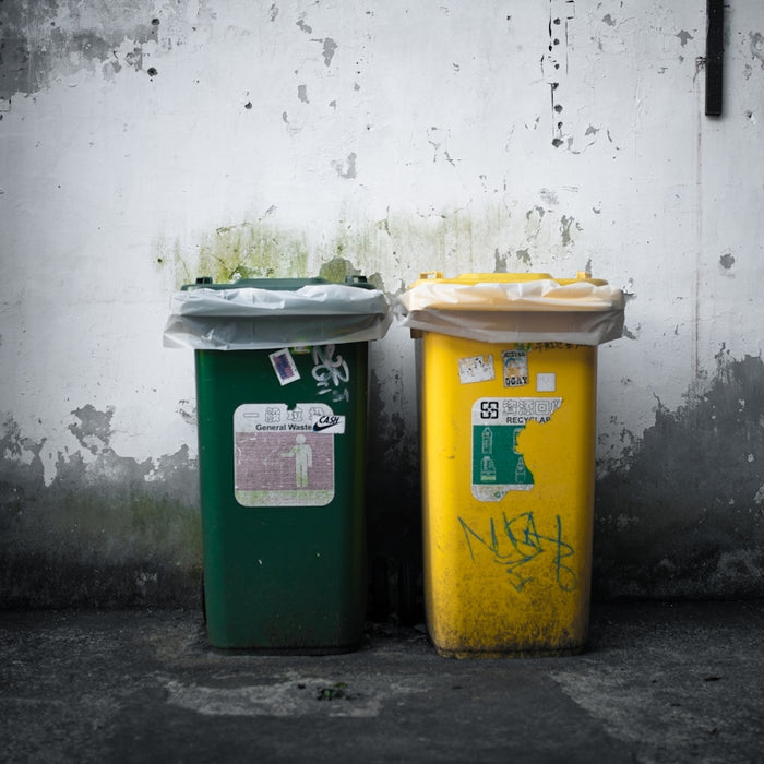 a couple of trash cans sitting next to each other