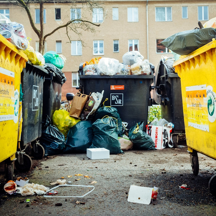 a group of trash cans sitting next to each other