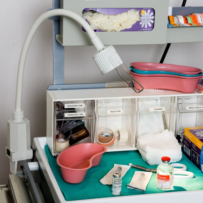 a cluttered desk with a hair dryer, hairdryer, and other