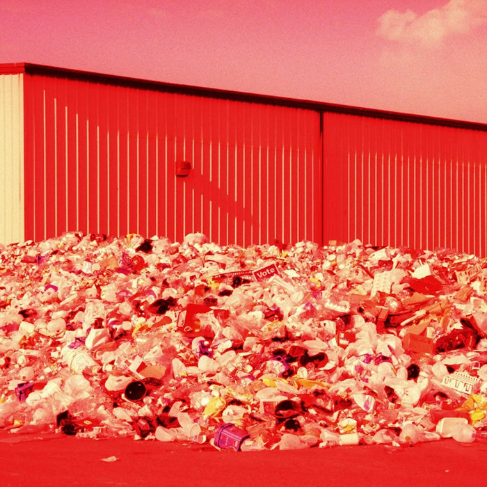 a large pile of trash sitting in front of a building
