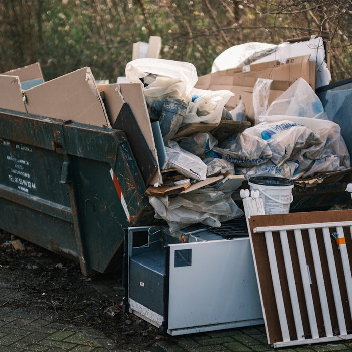 a pile of garbage sitting next to a pile of trash