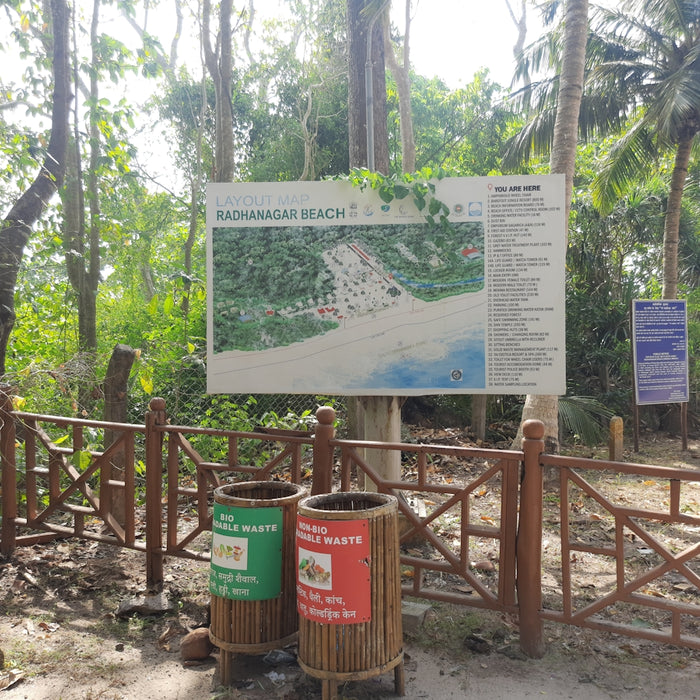 a sign in front of a wooden fence