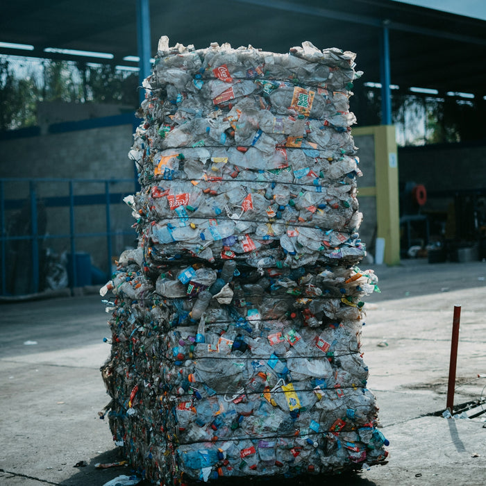 a large stack of garbage sitting in front of a building