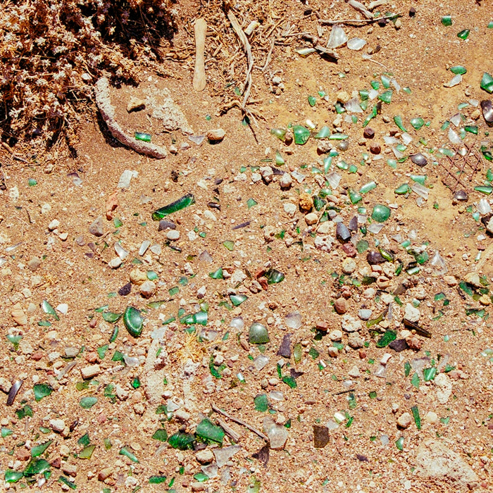 A bunch of broken glass sitting on the ground