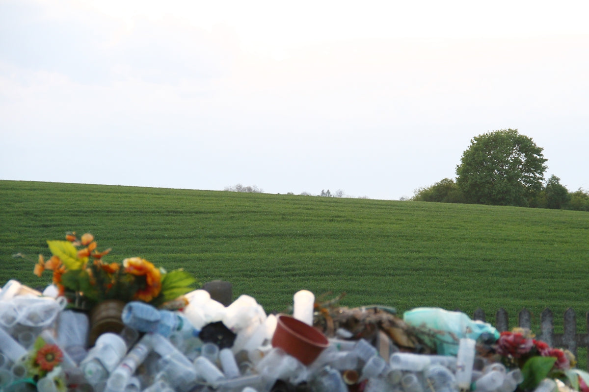 A large pile of plastic bottles sitting on the side of a road