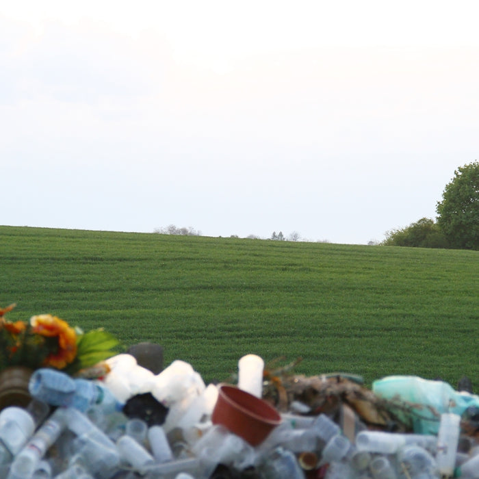 A large pile of plastic bottles sitting on the side of a road