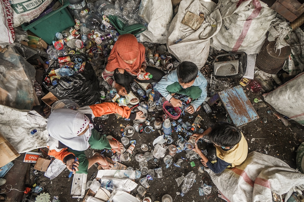 A pile of garbage with people standing around it