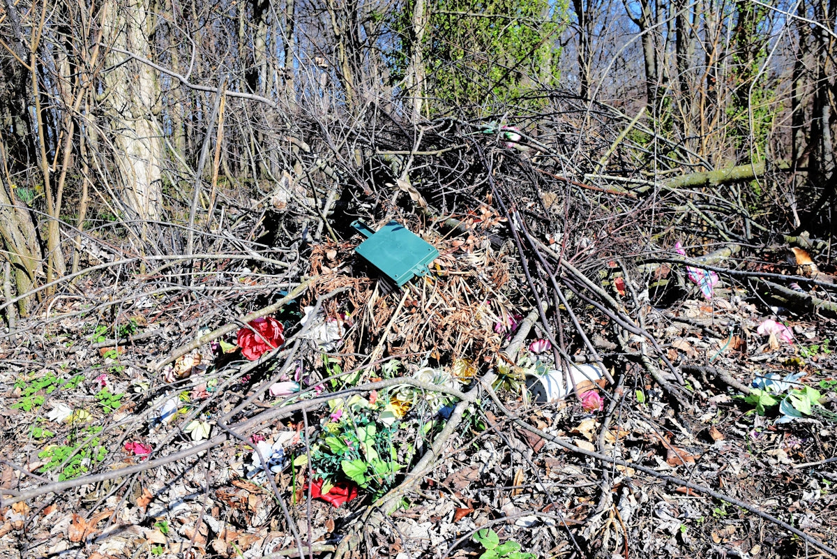 A pile of trash sitting in the middle of a forest