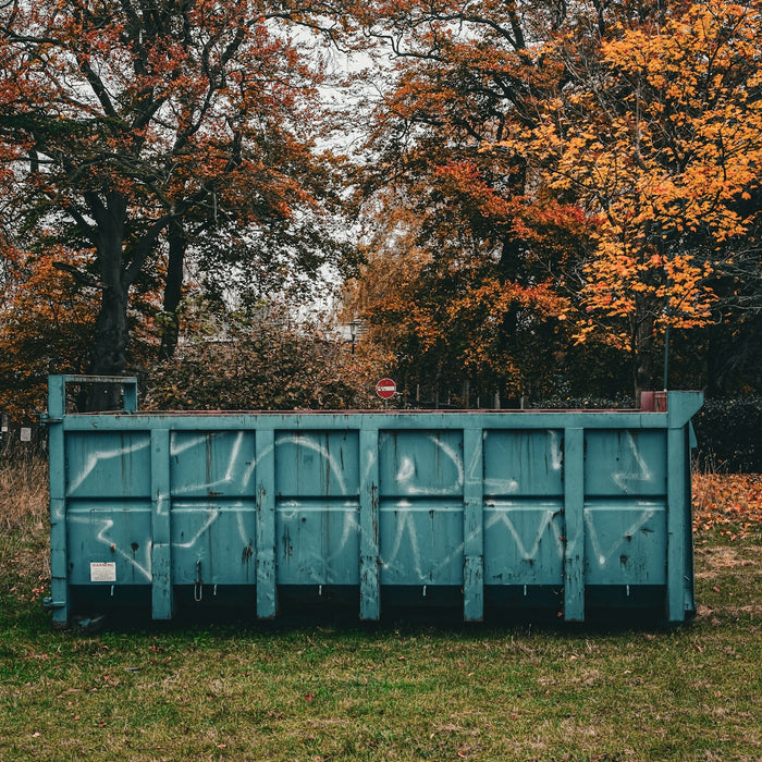 A blue box sitting on top of a lush green field