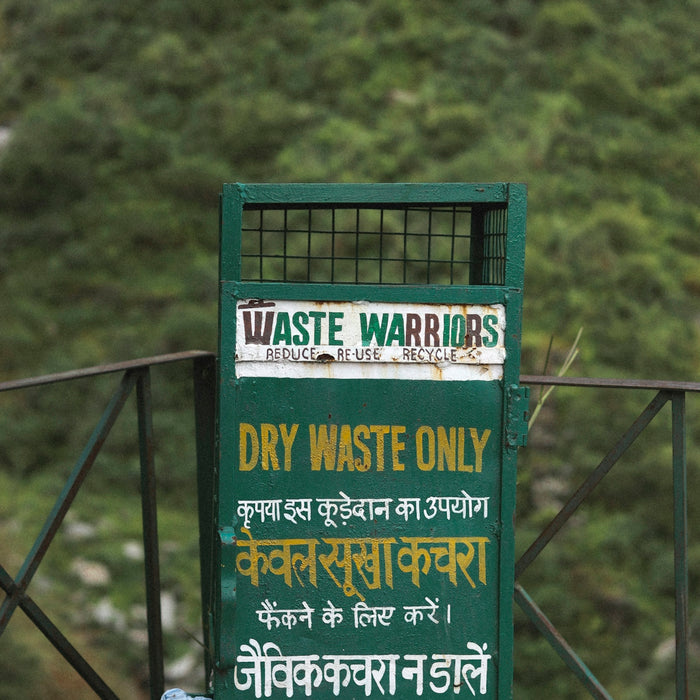 A sign on a bridge that says waste warriors dry waste only no food waste