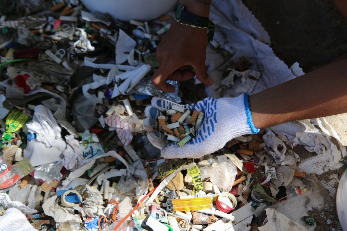 Someone is collecting trash with gloves.