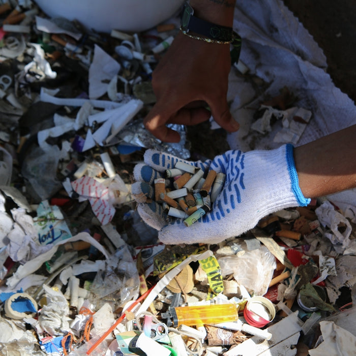 Someone is collecting trash with gloves.