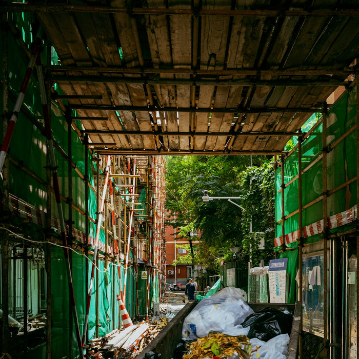 Construction site alley with a dumpster.