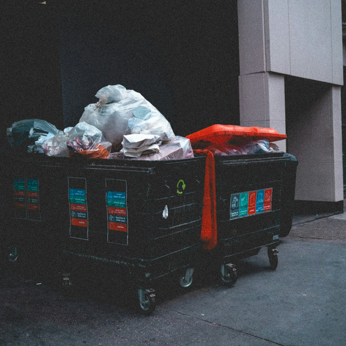 Overflowing trash bins outside a building