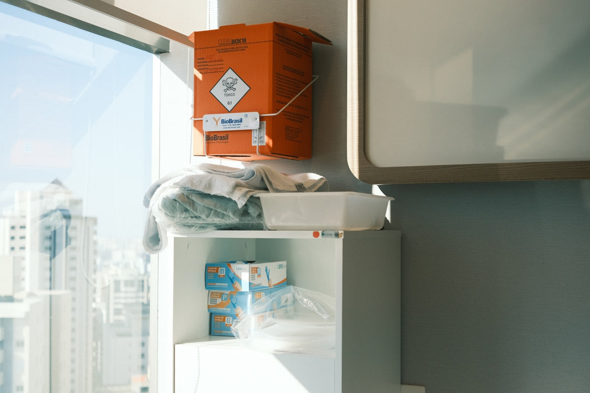 Orange biohazard bin above medical supplies