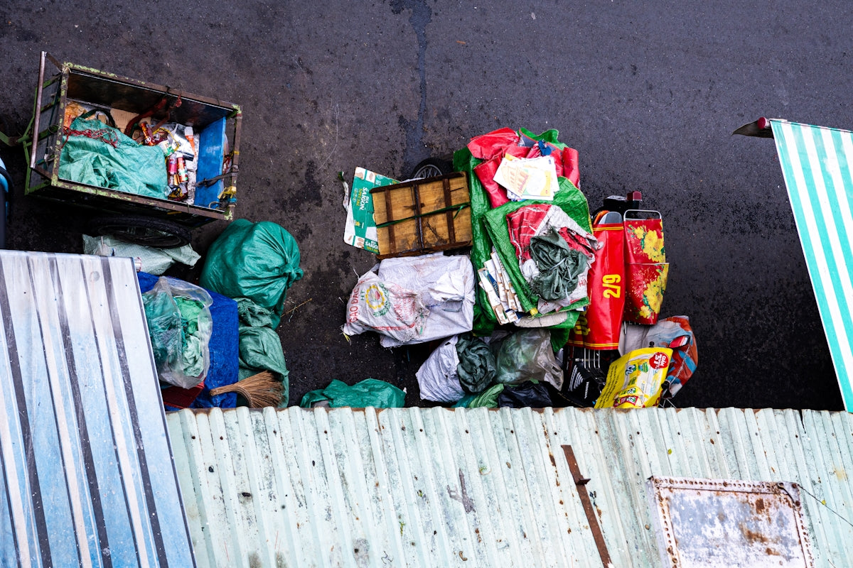 Pile of colorful plastic bags and trash against wall