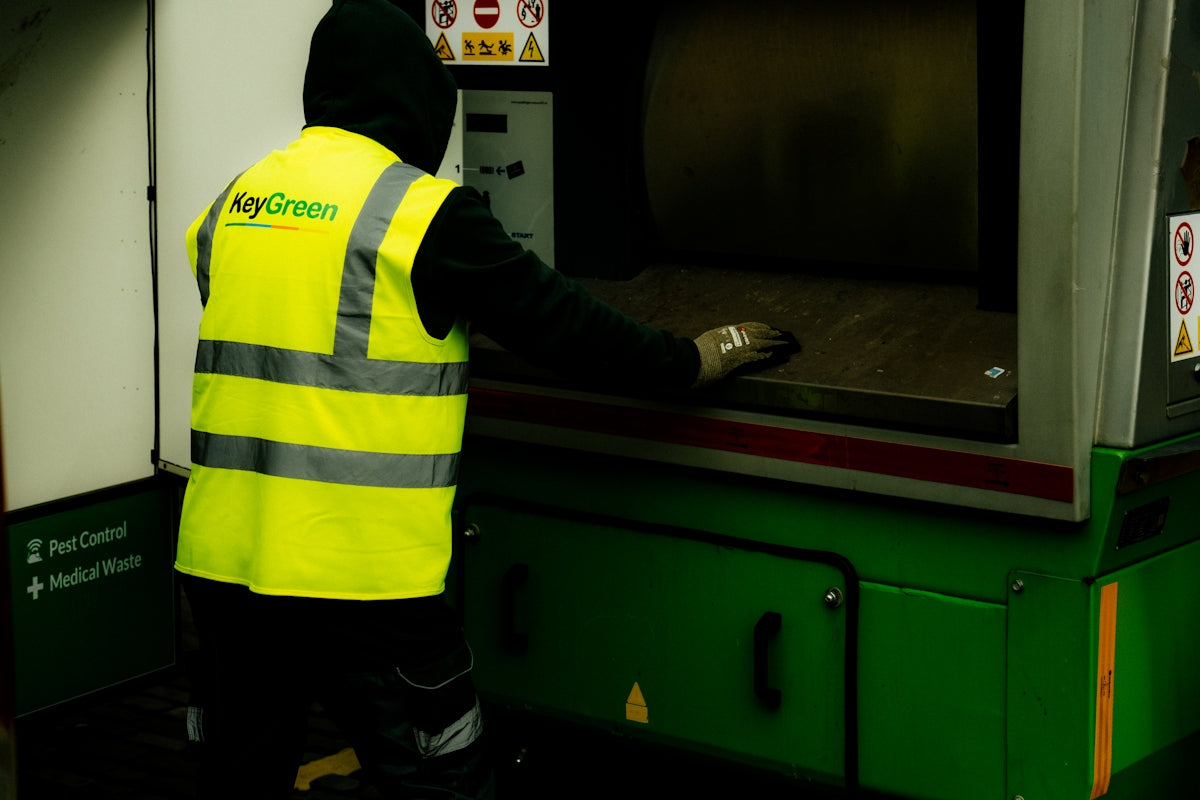 Worker in high-visibility vest operating machinery